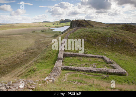 Milecastle 39 (o il castello di Nick) parte del Muro di Adriano in Northumnberland Parco Nazionale. Falesia di Lough è visto in lontananza Foto Stock