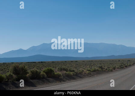 Viaggi in auto. L'estate. Destinazione di vacanza. Vista sulle montagne e su strada. Valle di montagna. Cielo blu con le montagne. Aprire orizzonte. Foto Stock