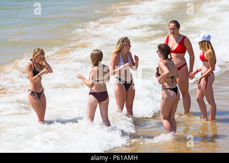 Bournemouth Dorset, Regno Unito. Il 28 giugno, 2018. Regno Unito: meteo sunseekers testa per le spiagge a Bournemouth su un altro caldo giorno soleggiato con ininterrotta in un cielo azzurro e sole. Una lieve brezza rende il calore più sopportabile. Un gruppo di amici in succinti bikini divertirsi giocando in mare. Credito: Carolyn Jenkins/Alamy Live News Foto Stock