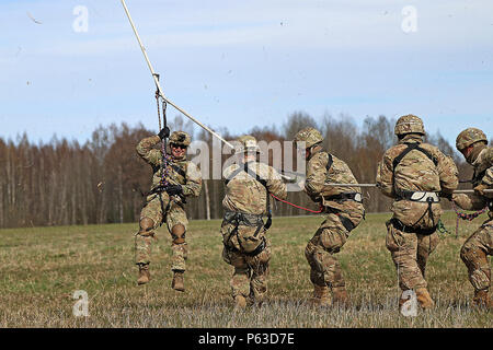 Stati Uniti I soldati dell esercito assegnato alla sede centrale e sede di truppe, 3° Stormo, 2° reggimento di cavalleria, tirare una corda collegata ad un lettone MI-17 elicottero come essi terra durante speciali scopo inserimento estrazione, formazione Lielvarde Air Base, Lettonia, 21 aprile 2016. Alleati dalla Lettonia, Canada, la Lituania e la Germania hanno partecipato all'evento che comprendeva a caldo e a freddo del carico sulla formazione UH-60 Blackhawk elicotteri e corda veloce inserimento di esercizi di estrazione. (U.S. Esercito foto di Sgt. Paige Behringer) Foto Stock