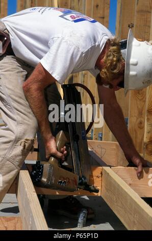 Carpenter edificio telaio a parete con pneumatici nailgun Foto Stock