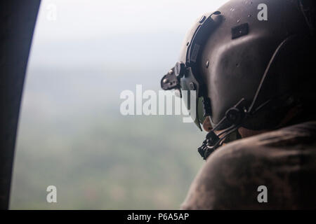 Stati Uniti Army Spc. Jordan Ford della 238th Task Force evacuazione medica Company, New Hampshire Guardia nazionale, scandisce il suo ambiente al fine di evitare ostacoli durante il volo in un UH-60 Black Hawk in elicottero Coatepeque, Guatemala, 27 maggio 2016. Task Force il lupo rosso e l'esercito a sud conduce civile umanitario Assistenza Formazione per includere tatical livello i progetti di costruzione e preparazione medica Esercizi di formazione fornendo accesso a medici e la costruzione di scuole in Guatemala con il governo Guatamalan e non le agenzie di governo dal 05MAR16 a 18GIU16 al fine di migliorare la disponibilità di missione di noi Fo Foto Stock