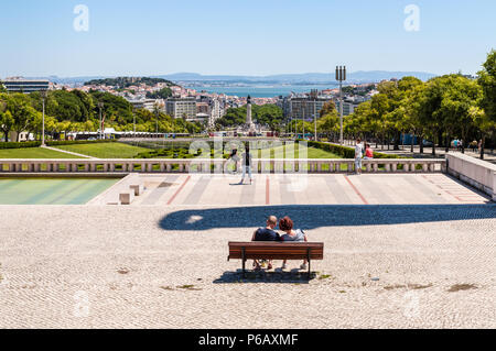 Lisbona, Portogallo - 19 Maggio 2017: Le persone sono a riposo nel parco e la città di Lisbona vista dal Parco Eduardo VII Viewpoint (Miradouro Parque Eduardo VII). Foto Stock