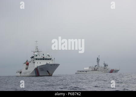 L'equipaggio della USCGC Alex Haley (WMEC 39) trasferisce la custodia dei detenuti peschereccio gestito da una repubblica popolare di Cina Coast Guard patrol nave nel mare del Giappone, 21 giugno 2018. L'Alex Haley e PRC Coast Guard equipaggi trattenuti la corsa da sospetta illegali di alto mare pesca con reti da posta derivanti. Stati Uniti La guardia costiera della foto. Foto Stock