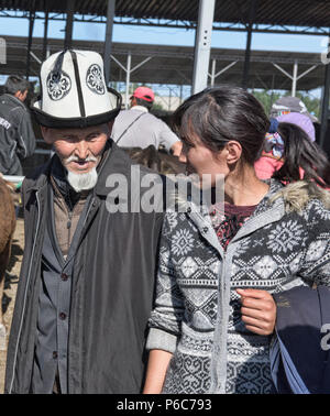 Uomo del Kirghizistan con kalpak hat alla domenica il mercato degli animali, Karakol, Kirghizistan Foto Stock