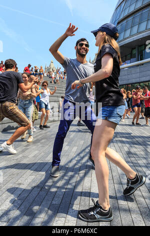 Il convogliatore a City Hall di Londra, UK, 1 luglio 2018. Un sizzling salsa cubana sessione, organizzato da l'Avana Londres scuola di ballo, introduce i londinesi e ai visitatori di ritmi e si muove di Salsa Cubana presso il convogliatore stadio, su una calda e soleggiata giornata a Londra. La salsa le sessioni sono parte dell'estate dal fiume festival. Le temperature sono di nuovo insieme per raggiungere circa trenta gradi nella capitale. Credito: Imageplotter News e sport/Alamy Live News Foto Stock