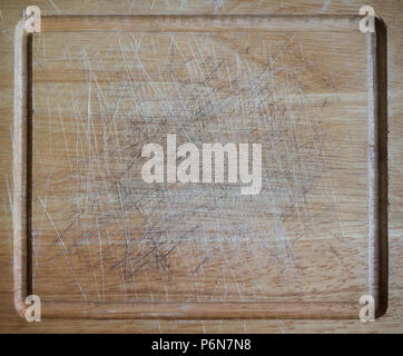 Telaio completo sullo sfondo di un vecchio tagliere di legno con tracce di taglio Foto Stock