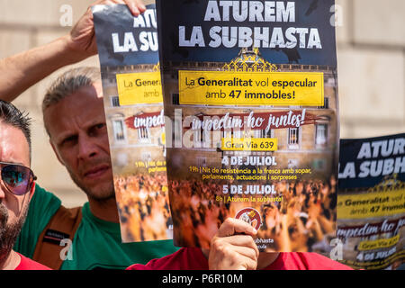 Barcellona, Spagna. Il 2 luglio 2018. Un poster della chiamata del 5 luglio è visibile in primo piano. La Generalitat della Catalogna intende auction questa settimana 47 proprietà dal 'intestada' eredità. Nonostante il fatto che dal Dipartimento di Economia della Generalitat assicura che la raccolta passa per le spese sociali che essi si arresta la AUC Credito: SOPA Immagini limitata/Alamy Live News Foto Stock