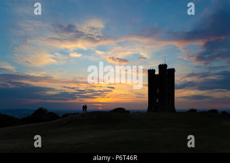 Torre di Broadway stagliano al tramonto con il giovane ammirando la vista sulla valle di Evesham, Broadway, Cotswolds, Worcestershire, England, Regno Unito Foto Stock