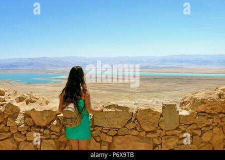 Una giovane ragazza guarda al Mar Morto. Rovine del Castello Herods nella fortezza di Masada in Israele Foto Stock