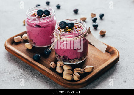 Gourmet sano frullato rosa con muesli, noci e bacche Foto Stock