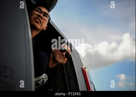 2 Lt. Kekai nu'uhiwa, un centro nella Air Force squadra di pallavolo, sinistra e 1Lt. Kevin Plascencia, una middle blocker sull'Air Force squadra di pallavolo, peer al di fuori di un CV-22 Osprey tilt-aeromobile a rotore dal 8 Special Operations Squadron al campo Hurlburt Fla., 11 maggio 2017. Il team è stato invitato a un tour del CV-22 22 per informazioni circa le sue capacità e missione all interno della Air Force Special Operations Command. Dopo il tour, il team assemblato alla pratica per i futuri giochi di pallavolo. Foto Stock