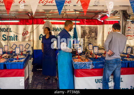 |un fornitore è aiutare i clienti al posto di mercato al Vismarkt a Groningen, Paesi Bassi 2018. Foto Stock