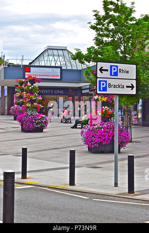 Attraenti composizioni floreali all'esterno dell'entrata anteriore al recentemente rinnovato e ridecorato Bridgend Shopping Center locali nel centro di Bridgend Foto Stock