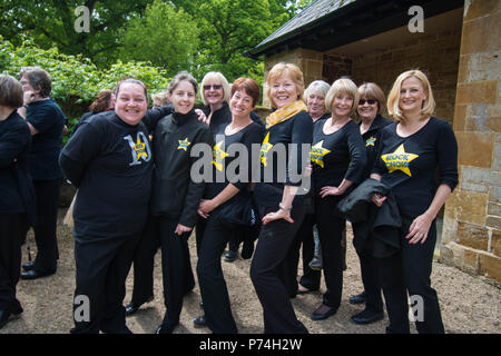 Rock Choir Althorp House in posa persone signore sorridere ragazze sorridenti signore bionde look guardare guardare prestazioni stile stile look look Foto Stock