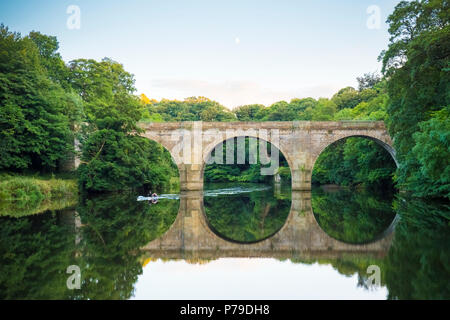 Due uomo scull Prebends sotto il ponte sul fiume usura nella città di Durham, Regno Unito Foto Stock