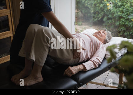 Fisioterapista dando un massaggio del corpo di donna senior Foto Stock