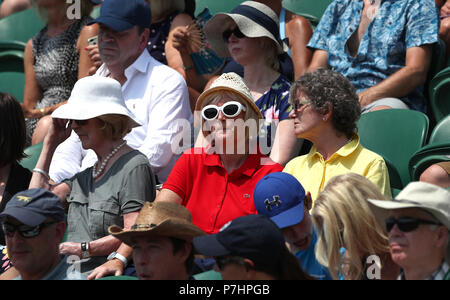 Spettatori proteggersi dal sole sulla corte 2 il giorno cinque dei campionati di Wimbledon al All England Lawn Tennis e Croquet Club, Wimbledon. Foto Stock