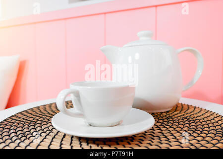 Set di bianco della tazza di caffè o di tè tazza e teiera bevanda calda in soggiorno Foto Stock