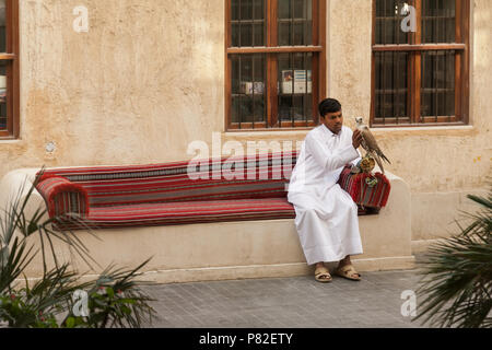 Giovane uomo tenendo un falco in Souq Waqif, Doha, Qatar Foto Stock