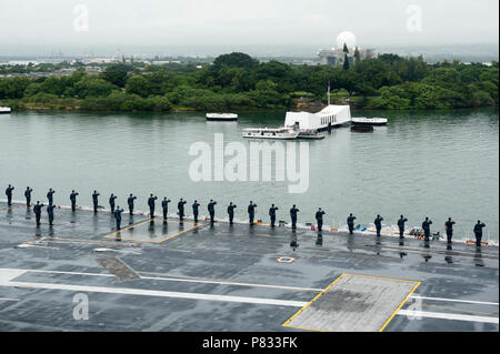 Oceano Pacifico (dec. n. 8, 2016) marinai rendere onora come USS John C. Stennis (CVN 74) passa la USS Arizona Memorial dopo ricevendo in corso da base comune Harbor-Hickam perla. John C. Stennis è in corso per condurre la formazione di routine dopo la partecipazione in nazionale a Pearl Harbor giorno del ricordo di eventi nelle Hawaii. Foto Stock