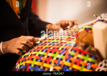 Chiudere l immagine di una donna con le mani in mano la tessitura alcuni panno. Foto Stock