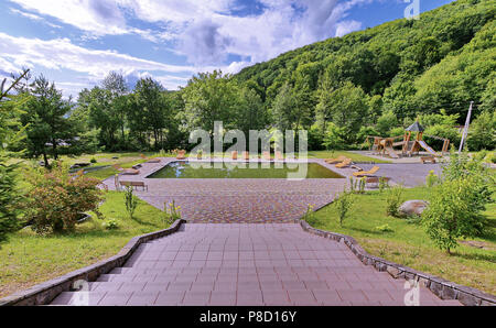 Una piccola piscina non ripuliti con lettini prendisole intorno ad esso. Non ci sono i vacanzieri nelle vicinanze . Per il vostro design Foto Stock