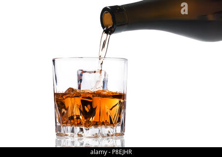 Versare il Whiskey a freddo in vetro isolato su sfondo bianco Foto Stock