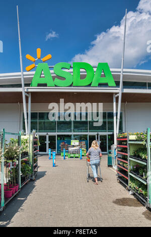 28 Maggio 2018: Newton Abbot, Devon, Regno Unito - supermercato Asda ingresso, con una donna spingendo un carrello verso di esso. Foto Stock