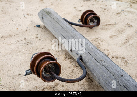 Un vecchio legno polo di alimentazione giacente a terra. Rotture di rete elettrica. Stagione di estate. Foto Stock