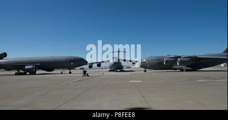 Un U.S. Air Force KC-10 Extender, C-5 M Super Galaxy e un C-17 Globemaster III sono parcheggiate sulla rampa durante il sessantesimo di mobilità in aria cambia ala del comando cerimonia al Travis Air Force Base, California, 10 luglio 2018. Col. John Klein rinunciato il comando di aria mobilità del comando parafango più grande al Col. Ethan Griffin. (U.S. Air Force Foto di Heide lettino) Foto Stock