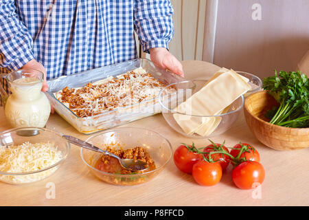 La casalinga cuochi lasagna di carne in cucina. cibo fatto in casa Foto Stock