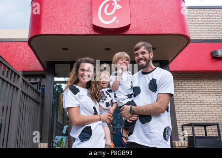 Una famiglia felice con loro in casa abiti di vacca per vacca apprezzamento giorno al Pulcino-fil-A, America's top-rated ristorante dal servizio veloce. (USA) Foto Stock