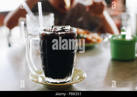 Iced caffè nero in vetro chiaro su una sete di giorno. Foto Stock