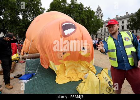 A sei metri di palloncino che illustra come il presidente statunitense Donald Trump un pannolino-placcati orange baby oltre la piazza del Parlamento durante il presidente del Regno Unito visita. Credito: Finnbarr Webster/Alamy Live News Foto Stock