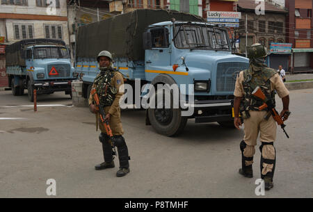 Srinagar Kashmir. 13 Luglio, 2018.indiano truppe paramilitari avviso sorge nei pressi di un Martire cimitero a Srinagar, la capitale estiva della controllata indiana Kashmir India, durante una cerimonia di premiazione che si terrà a segnare il martirio anniversario della Kashmiris ucciso dall'esercito di un re indù. Le autorità indiane a Srinagar distribuito migliaia di personale di sicurezza nelle principali città di Srinagar per impedire l'anti-Indiani proteste nell'area del centro cittadino di Srinagar. Credito: SOPA Immagini limitata/Alamy Live News Foto Stock