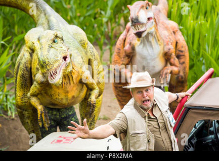 Agricoltore Tom Pearcy sorge accanto al suo labirinto che forma un Jurassic scena in cinque acri di campo di piante di mais a York Maze per il XXV anniversario di Jurassic Park. Foto Stock