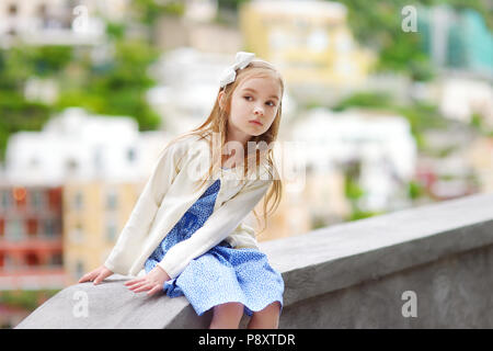 Adorabile bambina sul sole e caldo giorno d'estate in città di Positano in Italia Foto Stock
