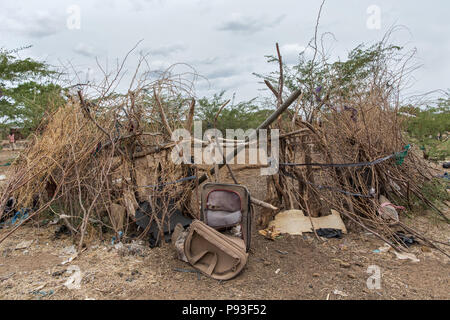 Kakuma, Kenya - Sul bordo del campo profughi di Kakuma, una valigia usurata simbolicamente sorge su un kraal abbandonati. Foto Stock