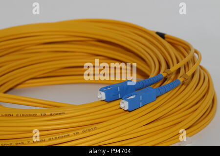 Aprire le fibre ottiche connettori SC modalità singola patch cord isolati su sfondo bianco Foto Stock