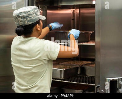 Airman 1. Classe Emerjann Degenova, xviii forze squadrone di supporto per il food service apprendista, prepara il riso luglio, 13, 2018, a Kadena Air Base, Giappone. La sala da pranzo Marshall Facility è il luogo primario di dormitorio-residente aviatori di avere i loro pasti. (U.S. Air Force photo by Staff Sgt. Jessica H. Smith) Foto Stock