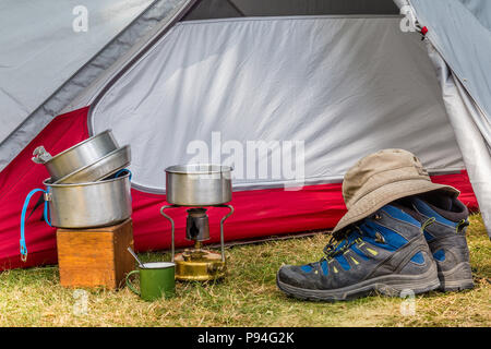 Campeggio in metallo rosso o tazza o tazza di avventura pic-nic tenuta in mano  da un maschio caucasico. Ambiente verde diurno, profondità di campo poco  profonda Foto stock - Alamy