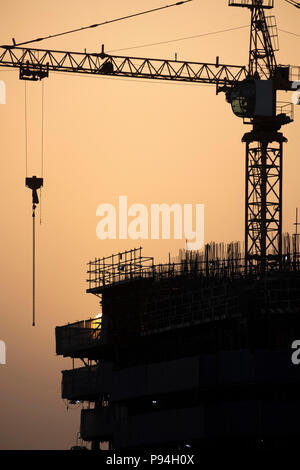 Sunrise nebuloso cielo di Dubai su sito in costruzione Foto Stock