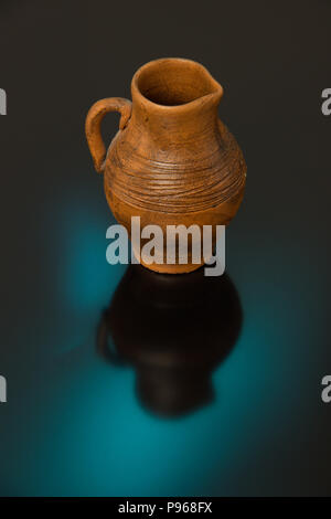 Vasi di ceramica con pattern scolpito su uno sfondo nero con il blu e il giallo luce Foto Stock