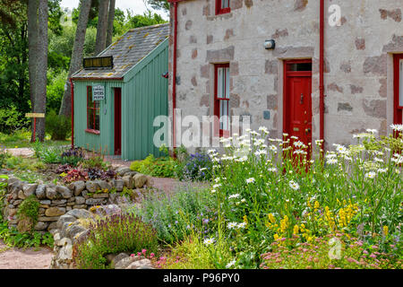 Tradizionale VECCHIO MULINO DI LANA KNOCKANDO MORAY Scozia edifici ristrutturati e fiori da giardino in estate Foto Stock