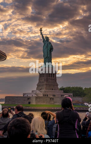 Vista al tramonto della Statua della Libertà dalla nave da crociera nel porto di New York Foto Stock