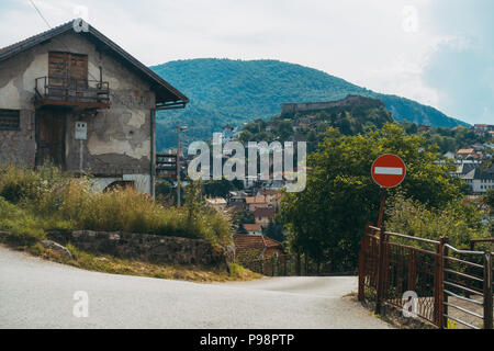 Una casa alla periferia di Jajce, con quello che sembra essere shrapnel danni all'esterno. La Fortezza Jajce si può vedere sulla collina dietro Foto Stock