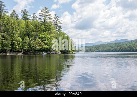 Kayaker femmina su un laghetto remoto nel deserto Adirondack Foto Stock