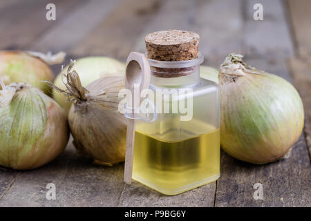Onion succo di frutta e verdura su un tavolo di legno. Fatti in casa a base di sciroppo per il trattamento dell'influenza. Sfondo scuro. Foto Stock