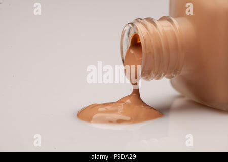 Una bottiglia di vetro e una base liquida che viene prelevato da esso Foto Stock